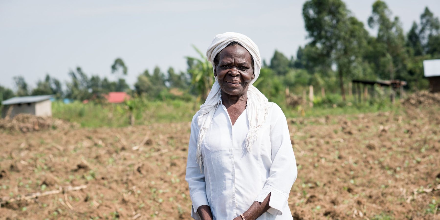 Theresa Wanyama stands in her field in Kenya