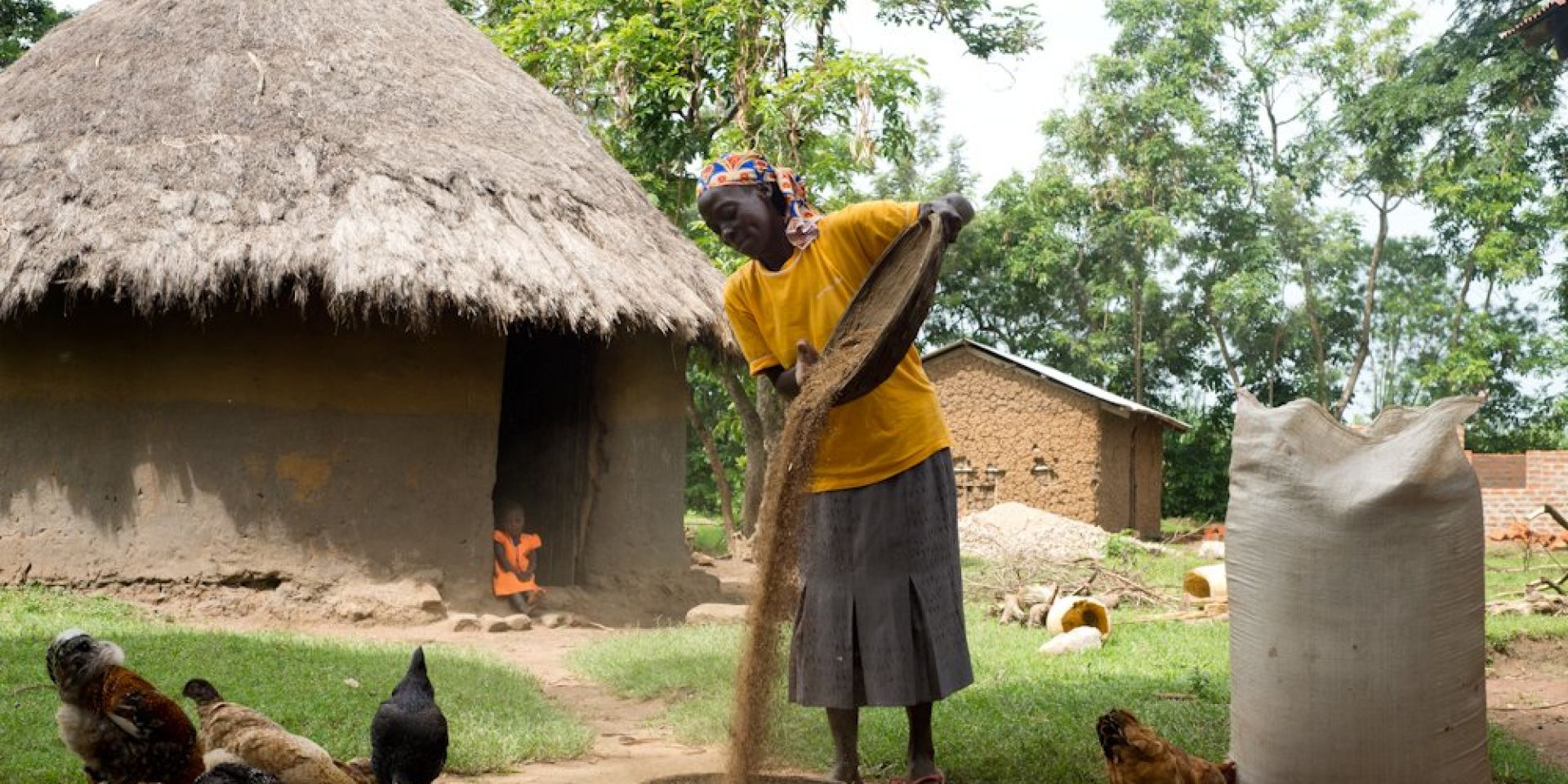 Women farmer with grains and chickens