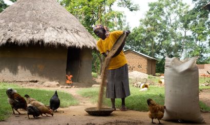 Women farmer with grains and chickens