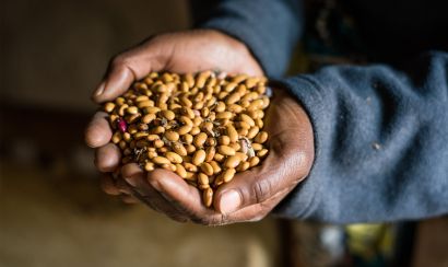 Pascaline of Burundi with beans in her hands