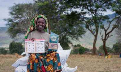 Female farmer with maize and training materials