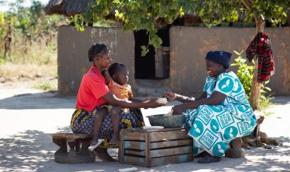 Trina Mwiinga sits with her family in Zambia
