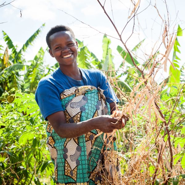 A farmer in Burundi stands in her field