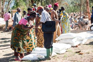 Farmers receiving delivery of farming inputs