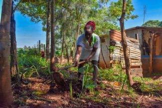 A young farmer tills her land in Kenya