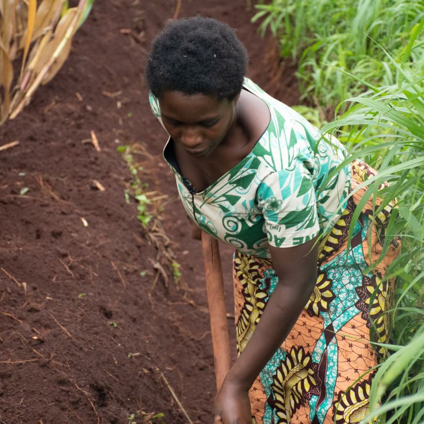 Asterie Ntahonvukiye hoeing her field