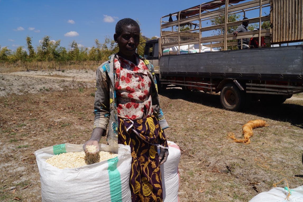 Germana stands with her bags of her maize.