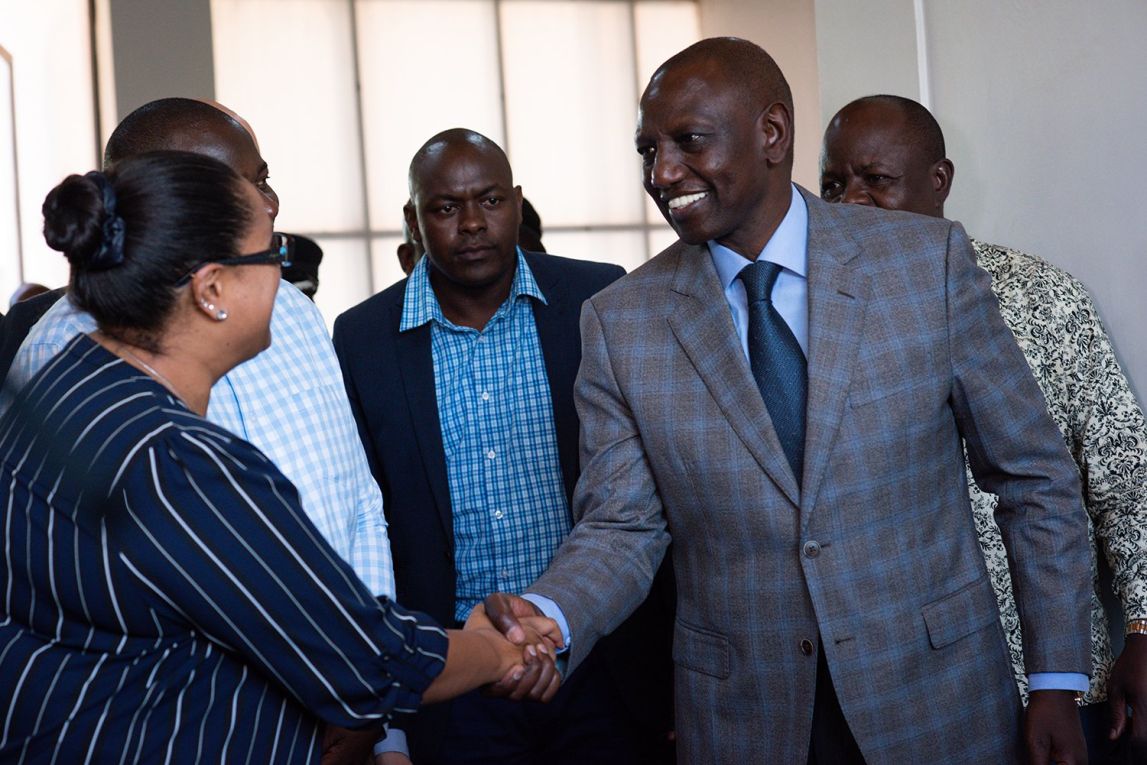 Kenyan Deputy President Dr. William Samoei Ruto greets a member of One Acre Fund's team
