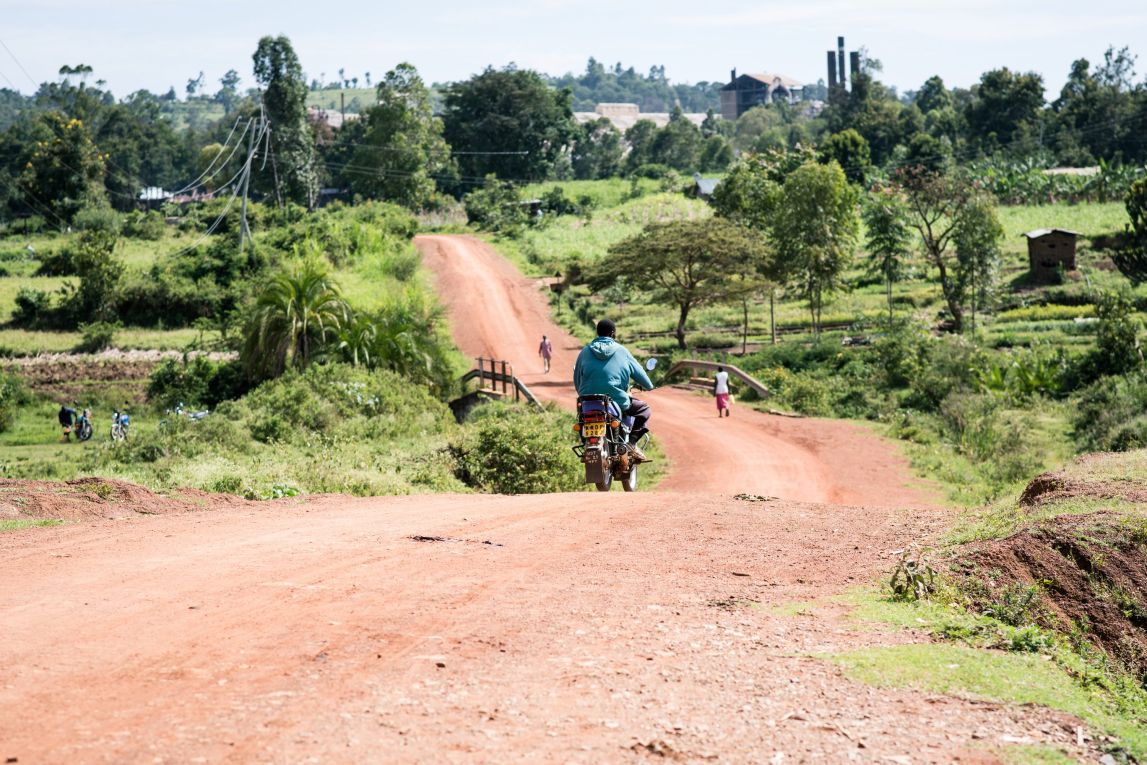 Person riding motorbike on a dirt road