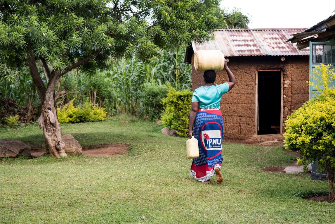 It is routine for Christine and women like her to carry jerrycans of water on their heads making several trips from a stream or a borehole nearby.
