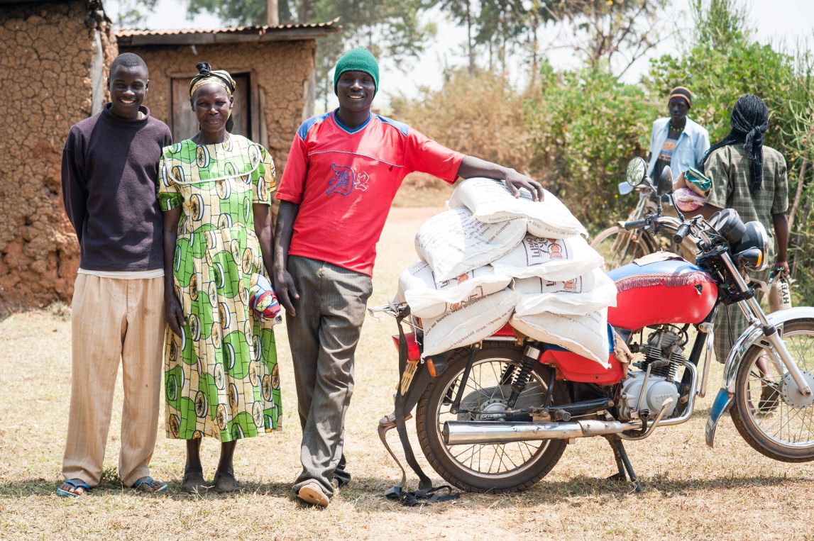 Farmers with motorbike and farm supplies