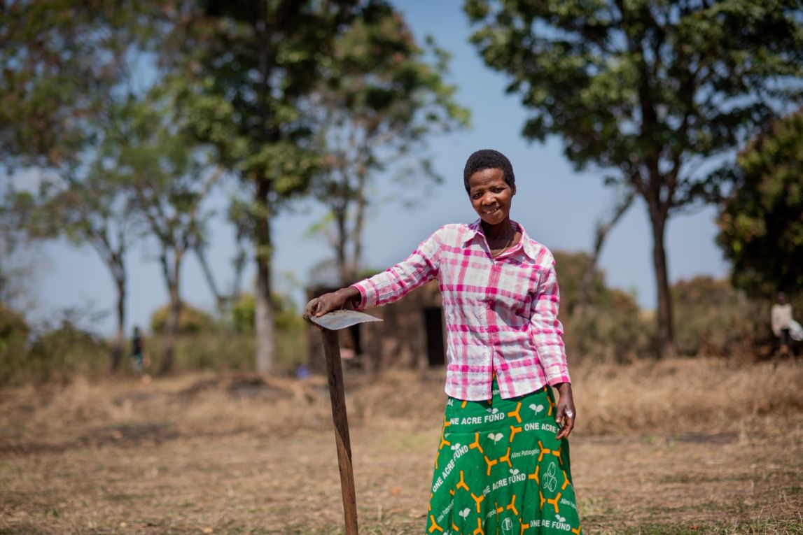 Rose January stands with her jembe near her home in Malawi